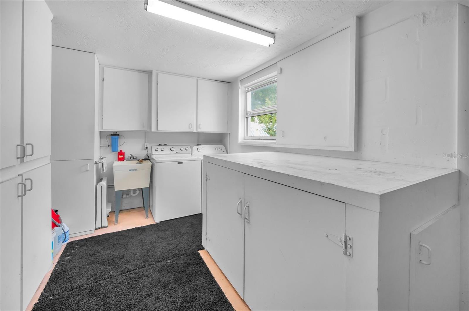 oversized garage laundry area with lots of cabinets