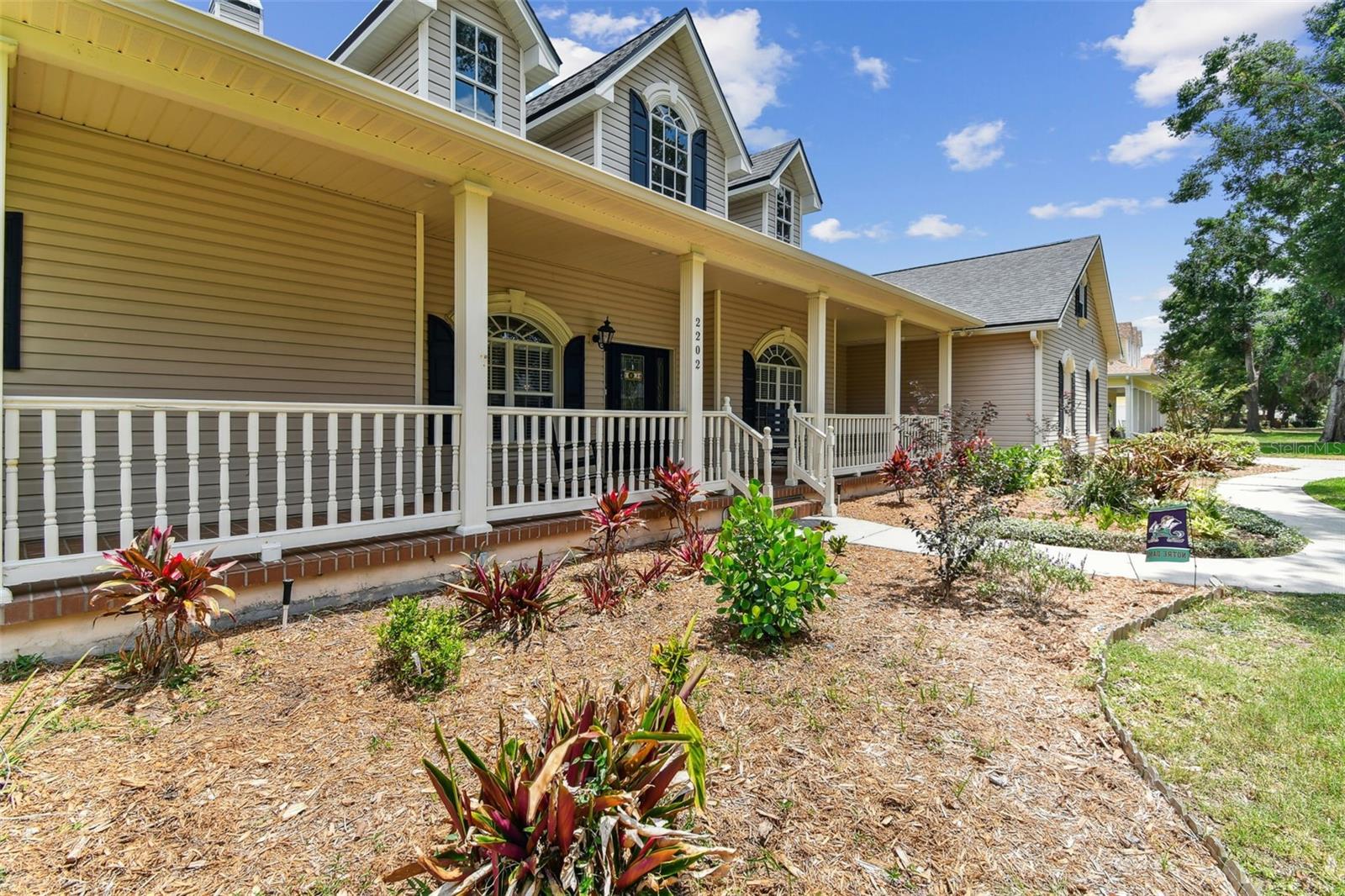 Front exterior view of 2202 Colewood Ln in Dover, Florida – with well maintained landscaping.