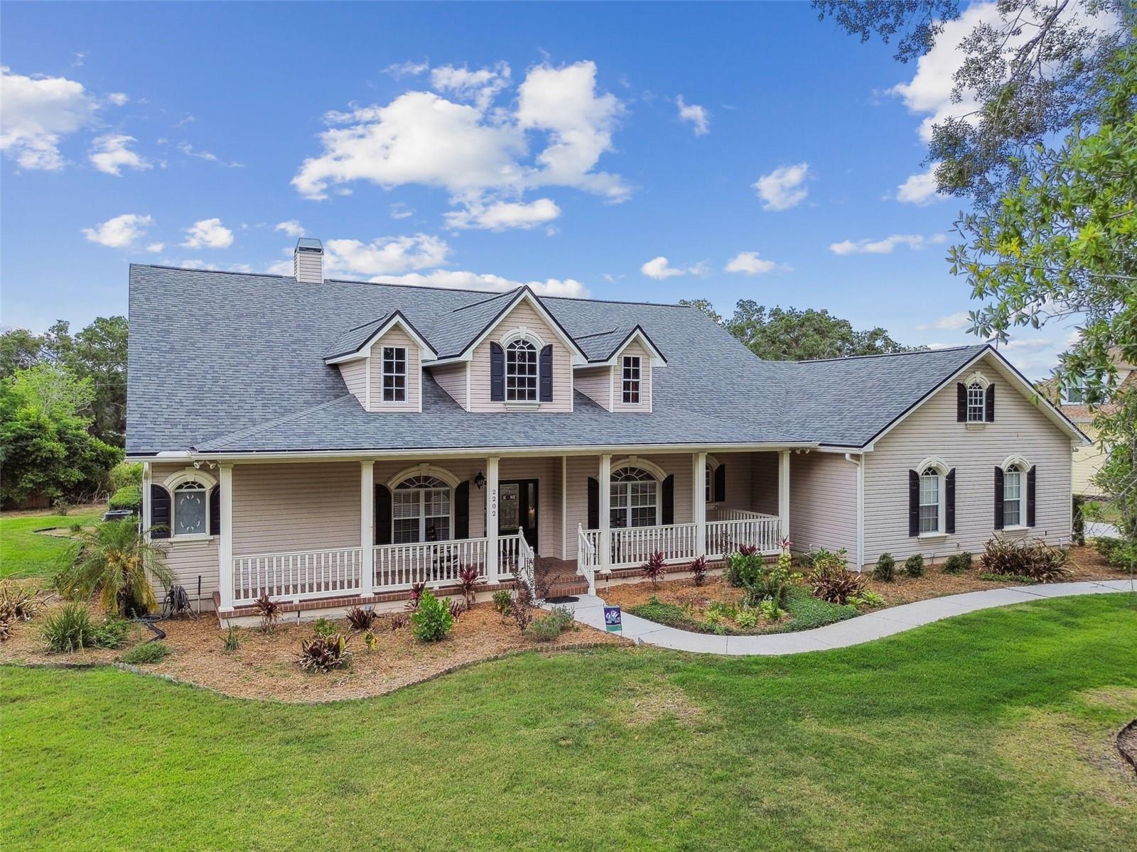 Front exterior view of 2202 Colewood Ln in Dover, Florida – with well maintained landscaping.