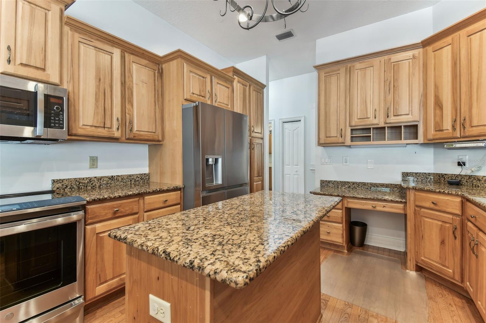 Modern kitchen at 2202 Colewood Ln with granite countertops, stainless steel appliances, and abundant cabinet space.