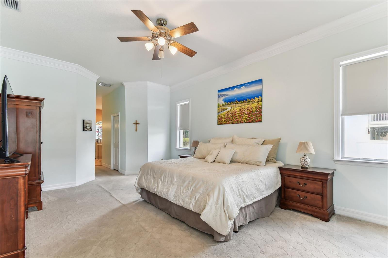 Spacious primary bedroom with large windows, and ensuite bathroom at 2202 Colewood Ln in Dover, FL.