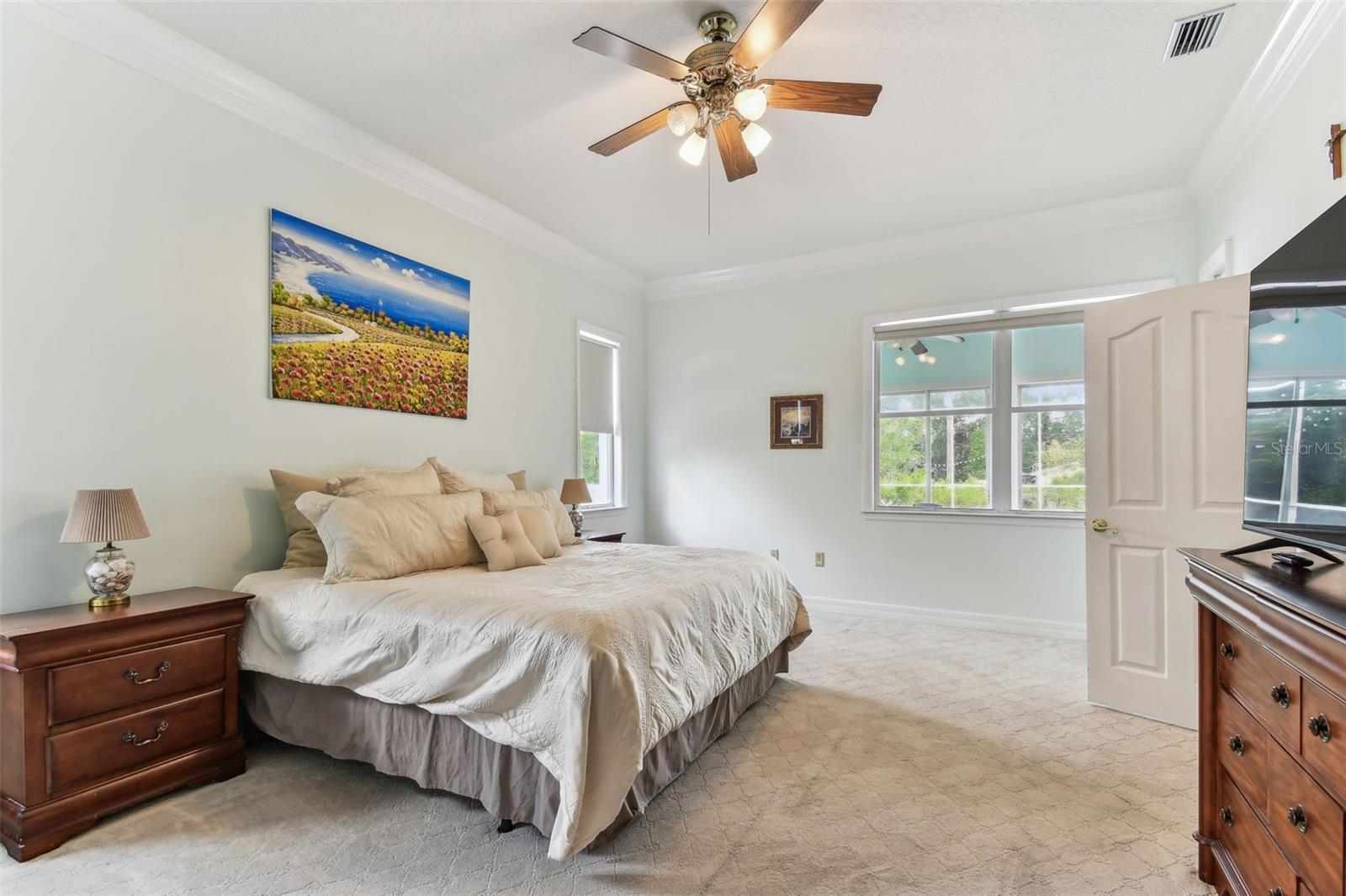 Spacious primary bedroom with large windows, and ensuite bathroom at 2202 Colewood Ln in Dover, FL.