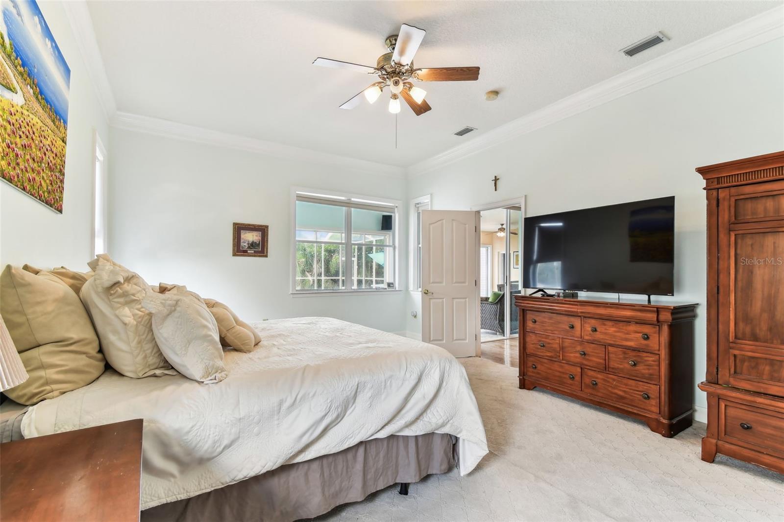 Spacious primary bedroom with large windows, and ensuite bathroom at 2202 Colewood Ln in Dover, FL.