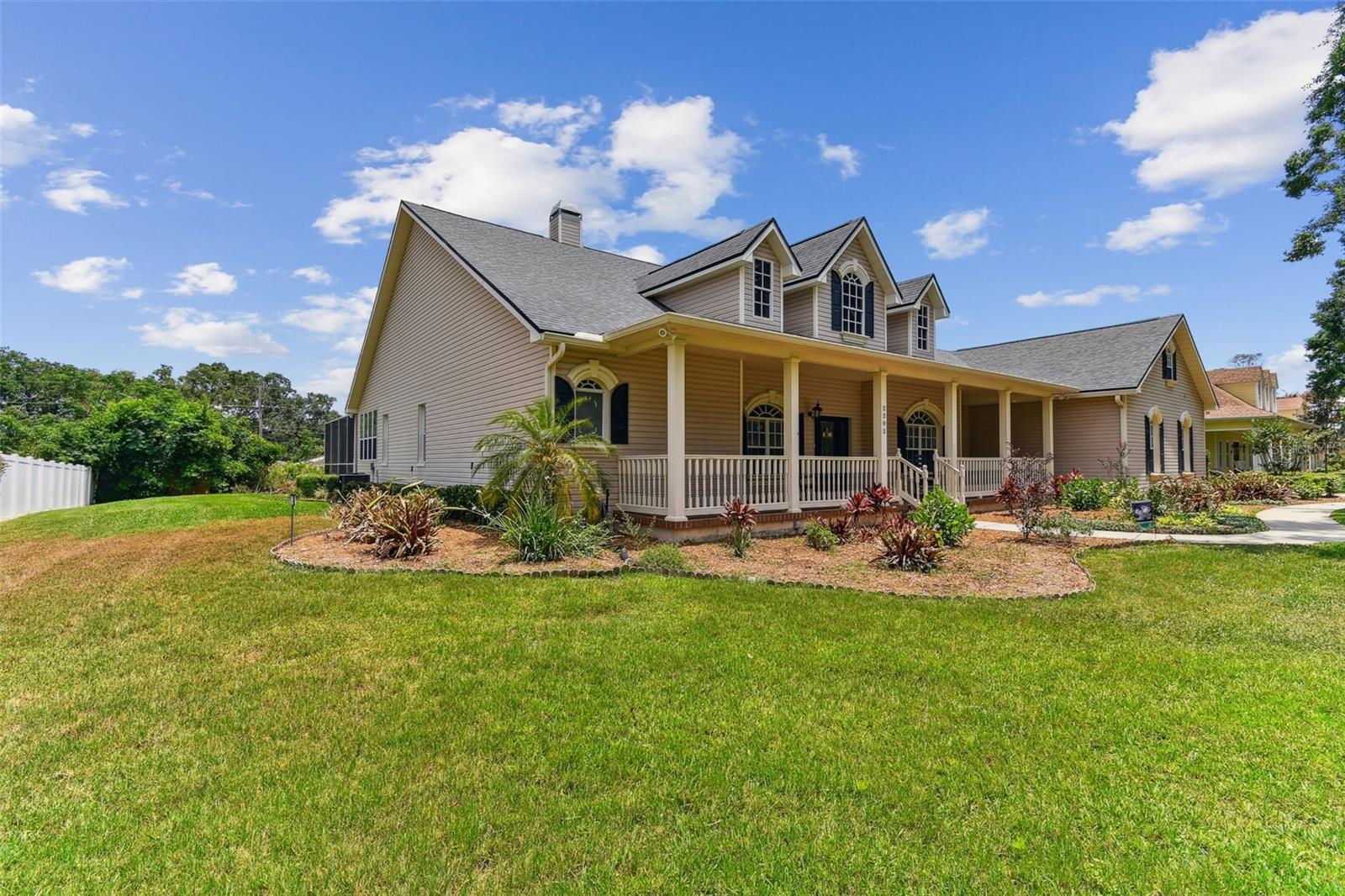 Front exterior view of 2202 Colewood Ln in Dover, Florida – with well maintained landscaping.