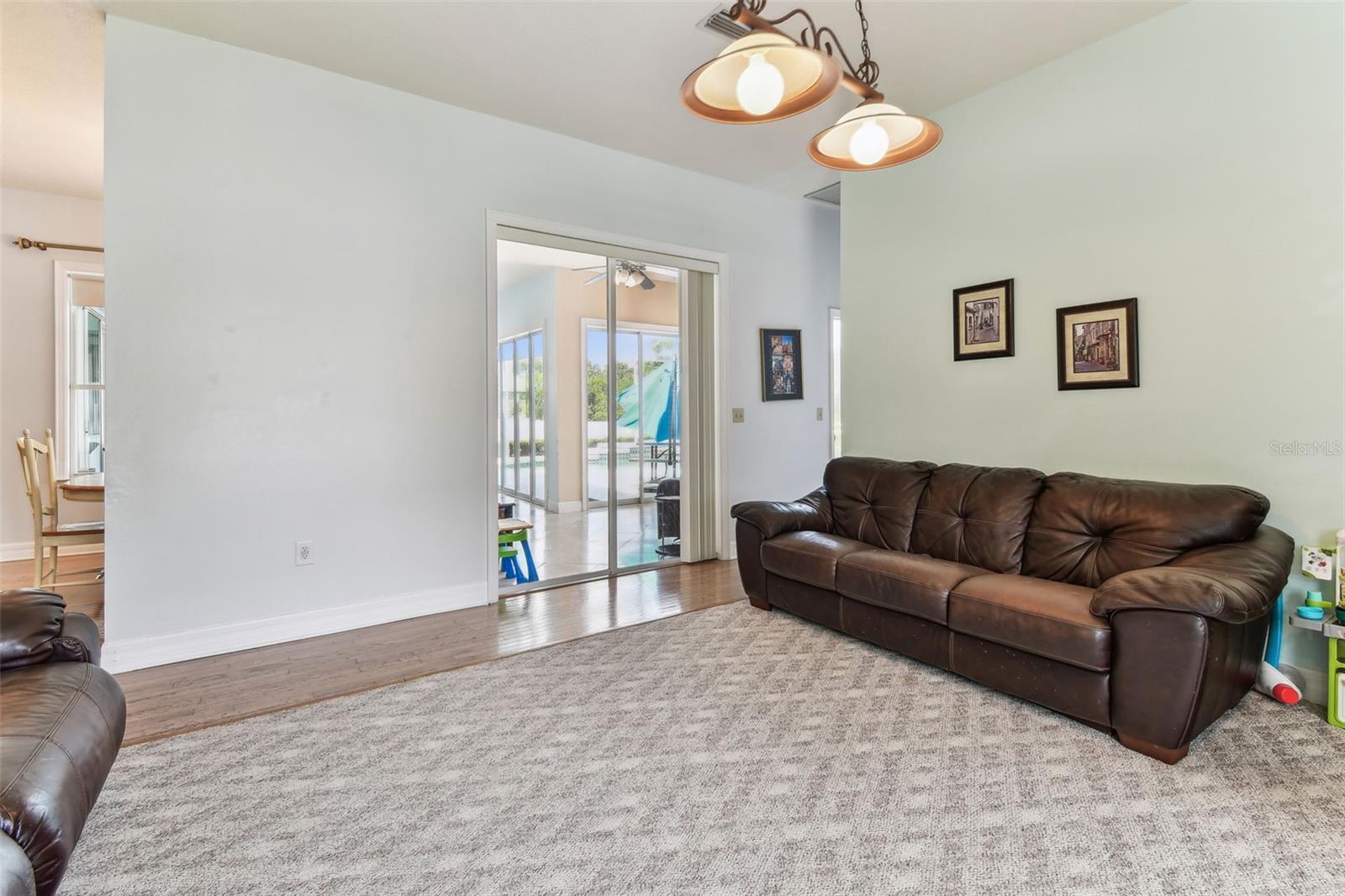 Cozy family room ideal for movie nights or gatherings, with direct access to the outdoor living space.