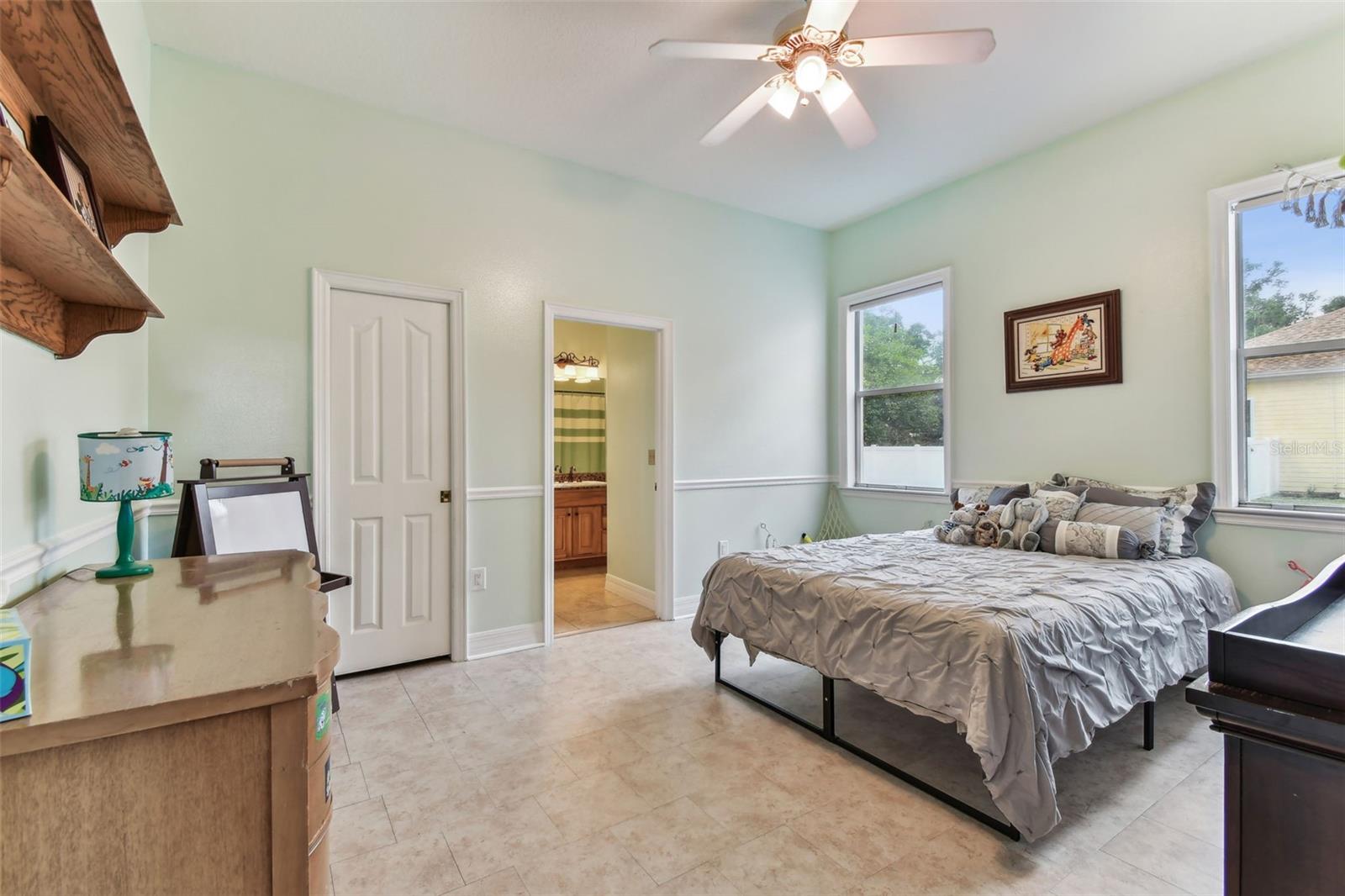 Comfortable guest bedroom with ample closet space and soft natural light — one of several bedrooms in this Dover FL home.