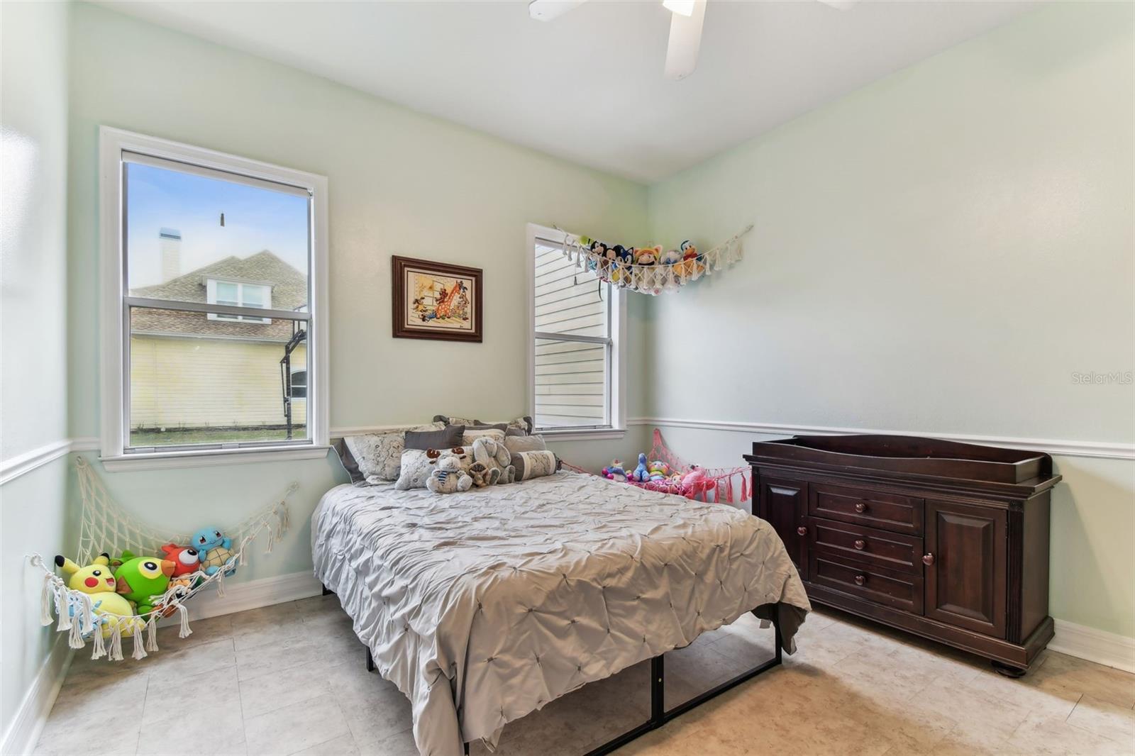 Comfortable guest bedroom with ample closet space and soft natural light — one of several bedrooms in this Dover FL home.