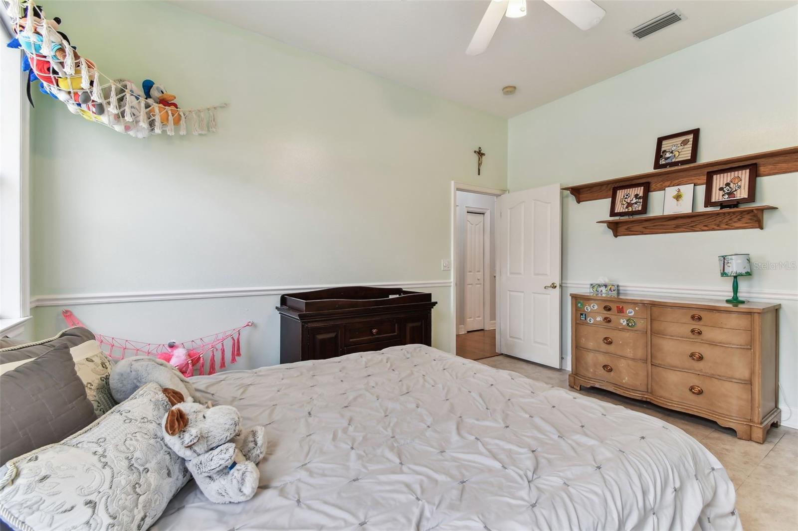 Comfortable guest bedroom with ample closet space and soft natural light — one of several bedrooms in this Dover FL home.
