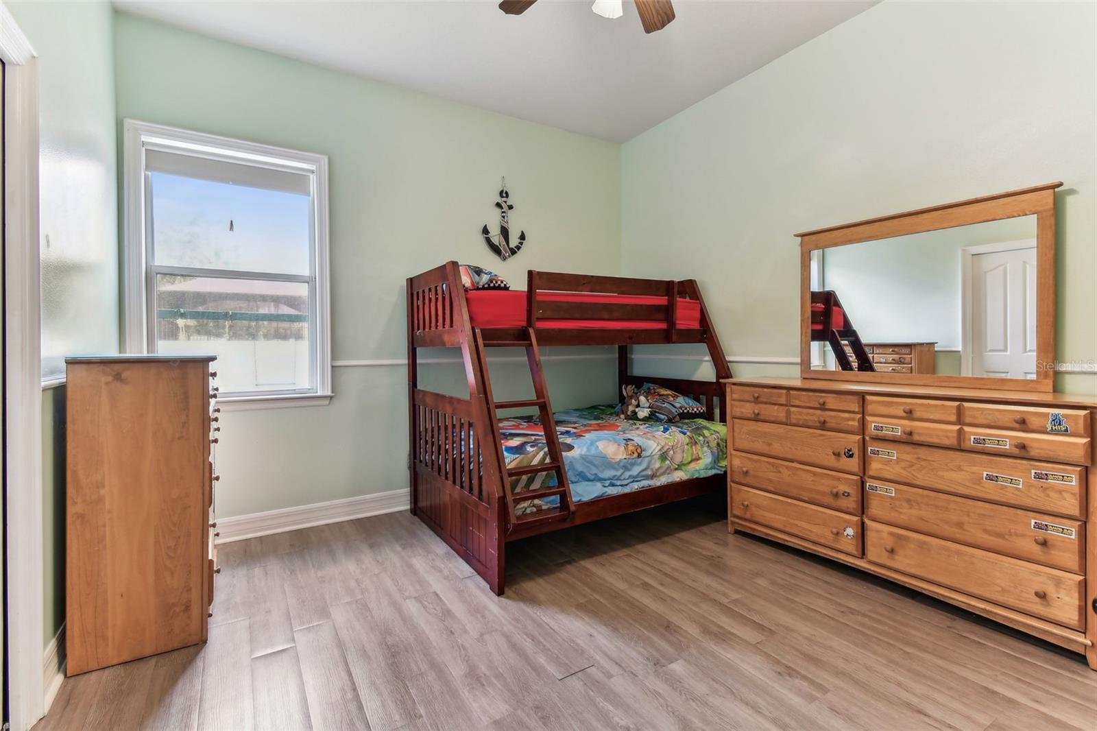 Comfortable guest bedroom with ample closet space and soft natural light — one of several bedrooms in this Dover FL home.