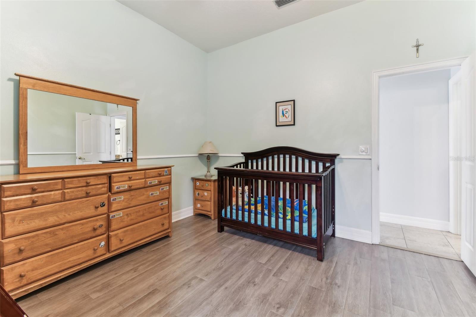 Comfortable guest bedroom with ample closet space and soft natural light — one of several bedrooms in this Dover FL home.