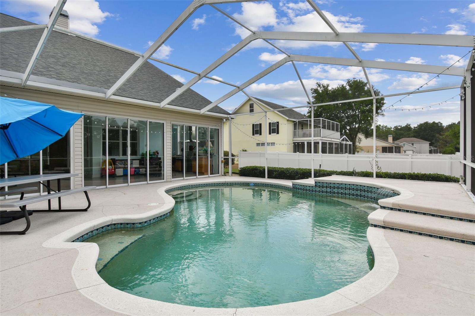 Private backyard pool with screened enclosure and patio area at 2202 Colewood Ln, perfect for Florida living and entertaining.