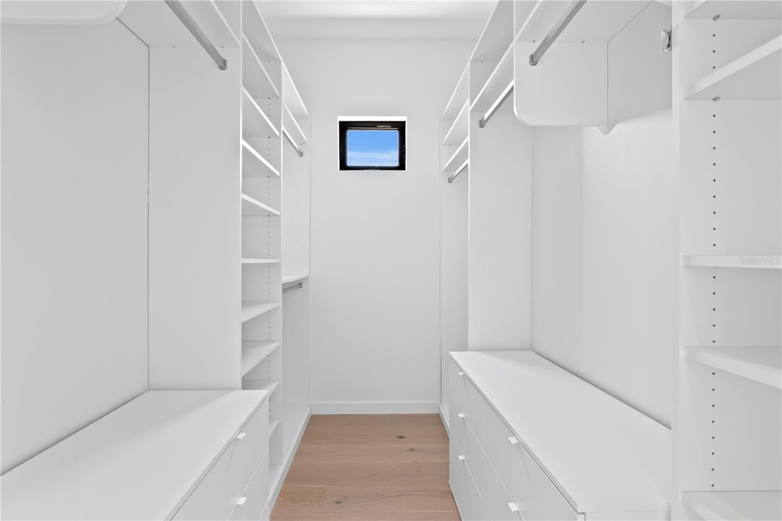 Primary bedroom walk-in closet
