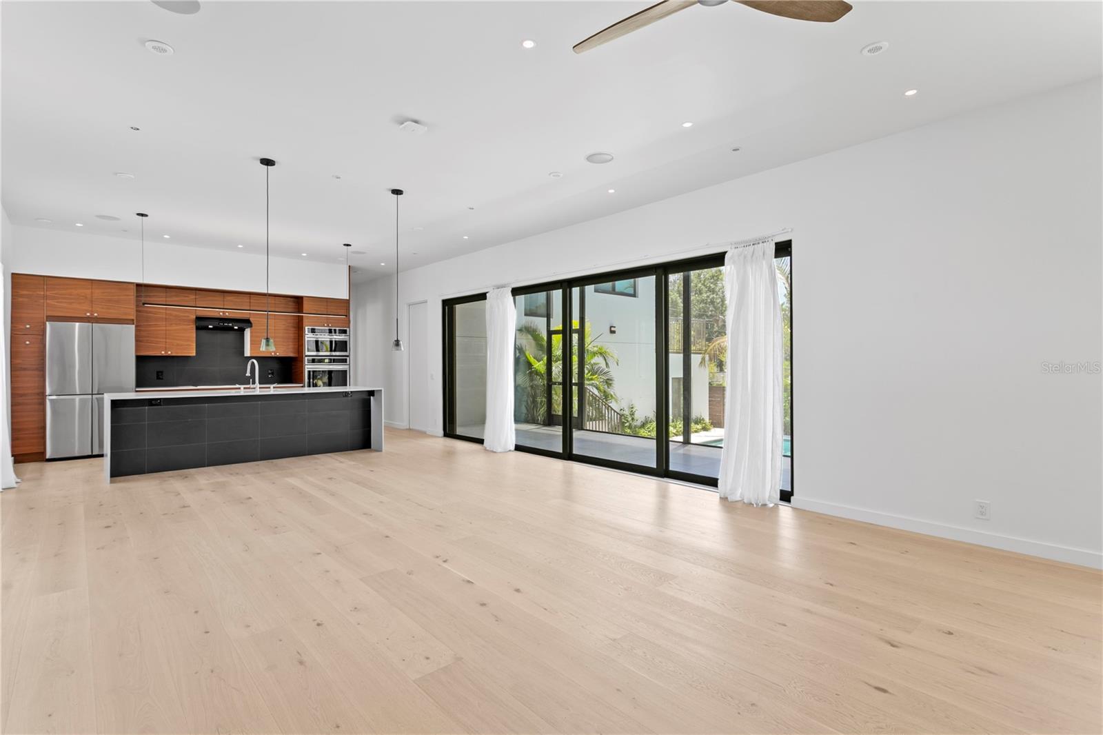 Living/dining space that leads to patio with triple sliding doors