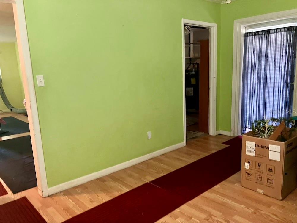 VIEW FROM FLORIDA ROOM - ENTRY ON LEFT LEADS TO KITCHEN/DINING & LIVING AREAS; DOOR ON RIGHT LEADS TO LAUNDRY ROOM