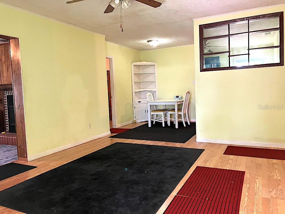 LIVING ROOM/VIEW FROM ENTRANCE LOOKING TWORDS DINING ROOM, LAUNDRY ROOM, (FLORIDA ROOM AND KITCHEN NOT IN VIEW) ; ENTRY ON THE LEFT LEADS TO THE FAMILY ROOM