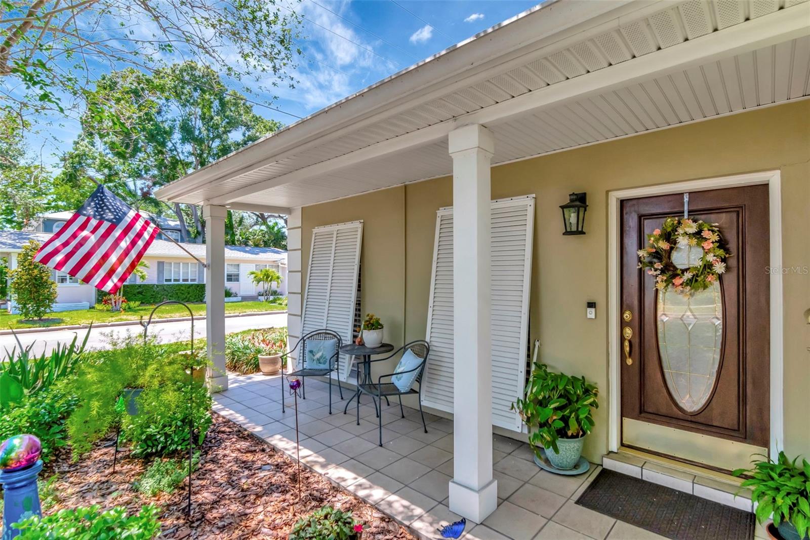 Great your neighbors while relaxing on your front porch overlooking a well landscaped yard.