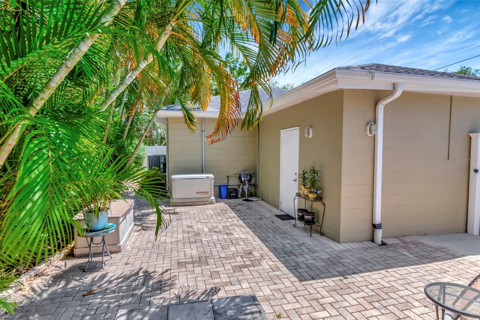 Patio wraps around house, extending outside living area.