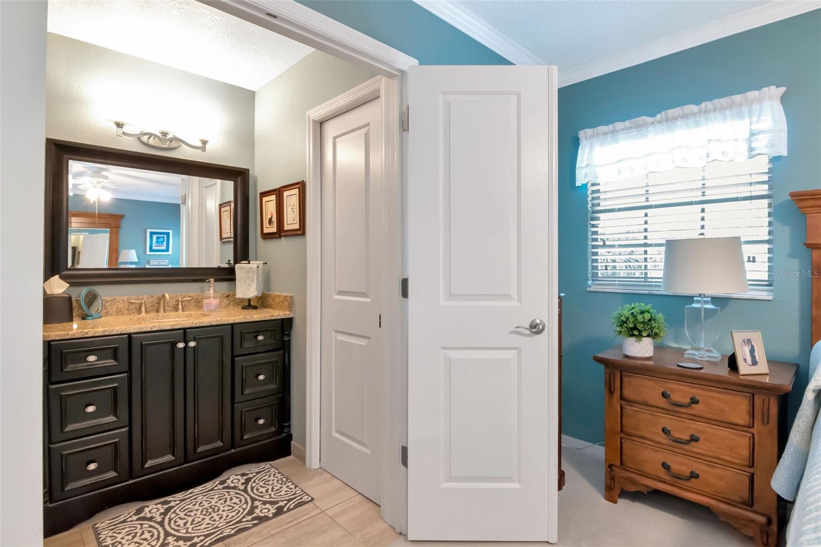 updated primary bath is accessible via double doors