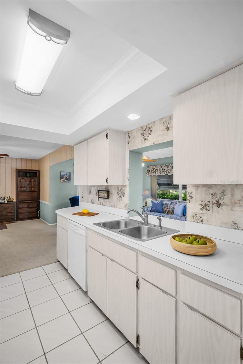 Kitchen pass-through open to sunny Florida room~