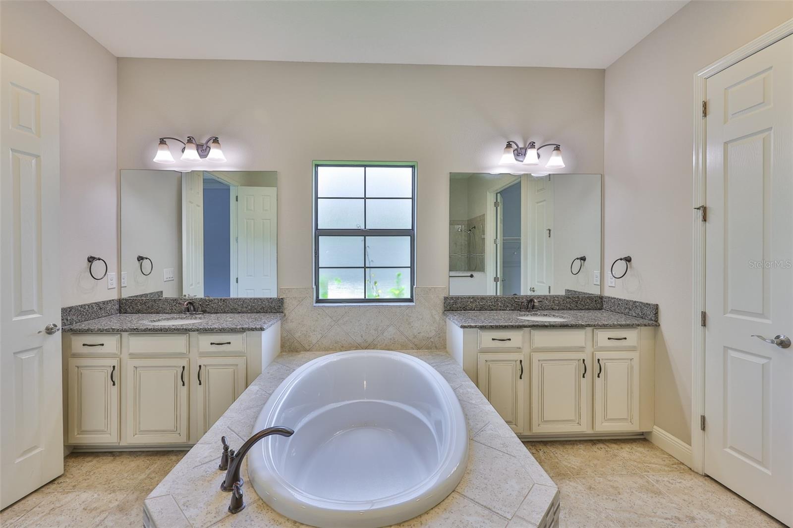 Primary bathroom - dual vanities, soaking tub