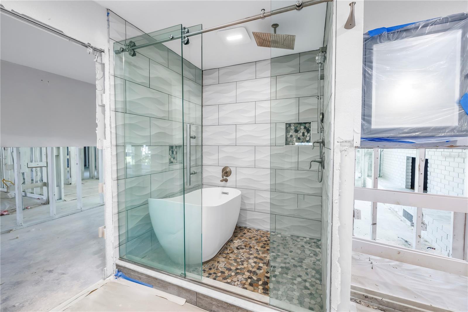 Main bathroom - lots of storage with glass enclosed shower