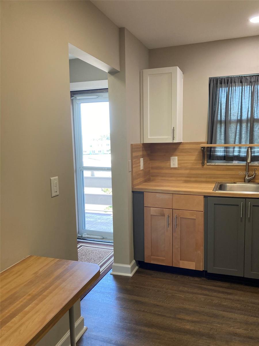 As you enter, the kitchen is on your left