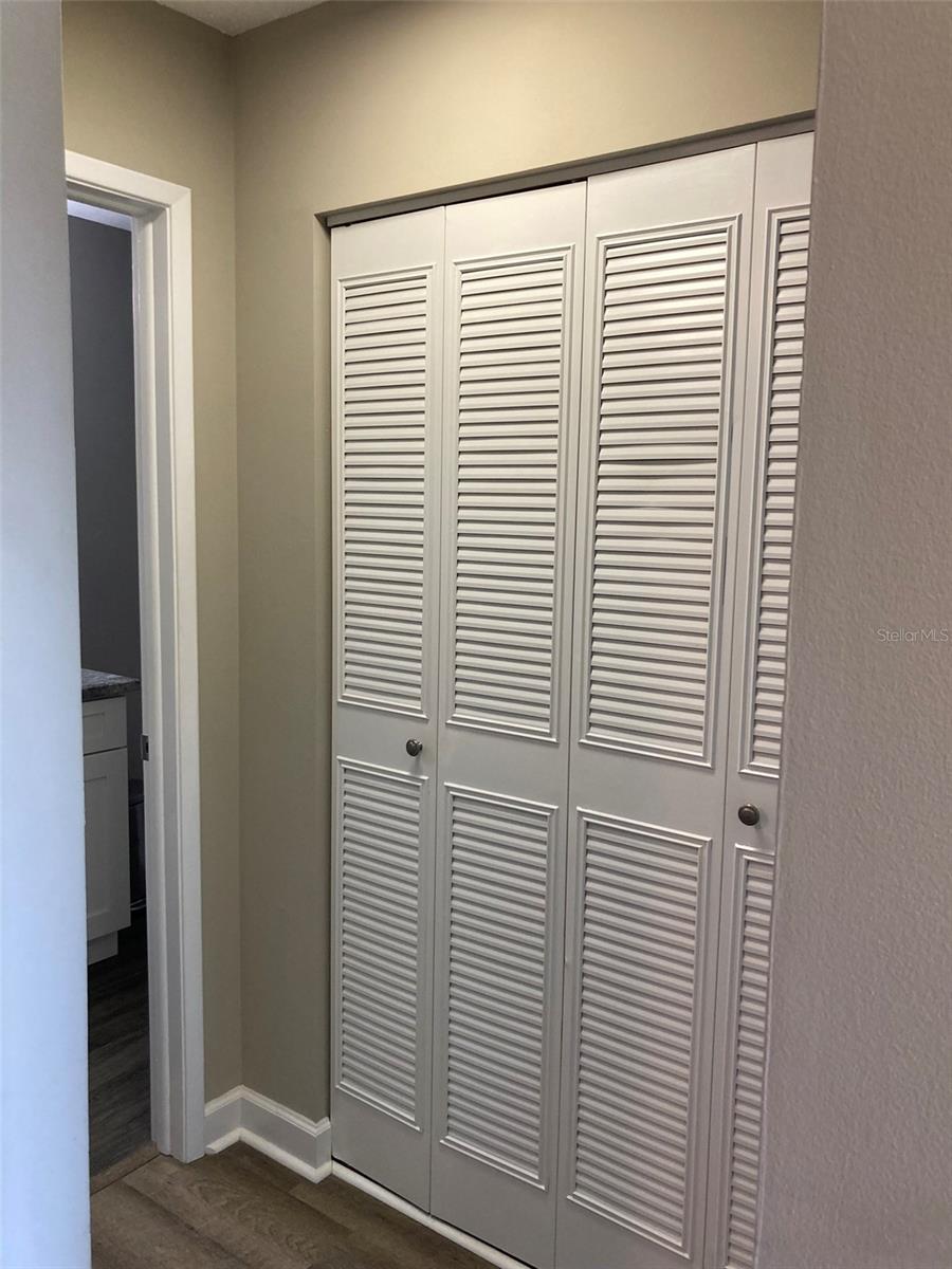 Hallway to bedroom and full bath - great storage in this closet.