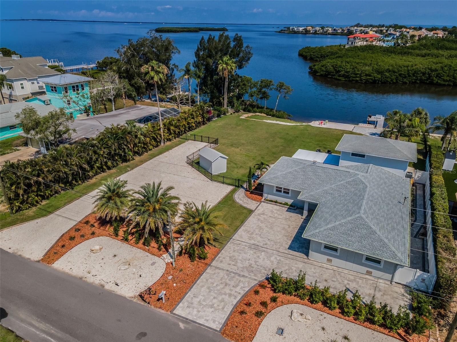 WELCOME HOME To Over a 1/2 Acre of Gulf Perfection Talk About Manicured Land & Home