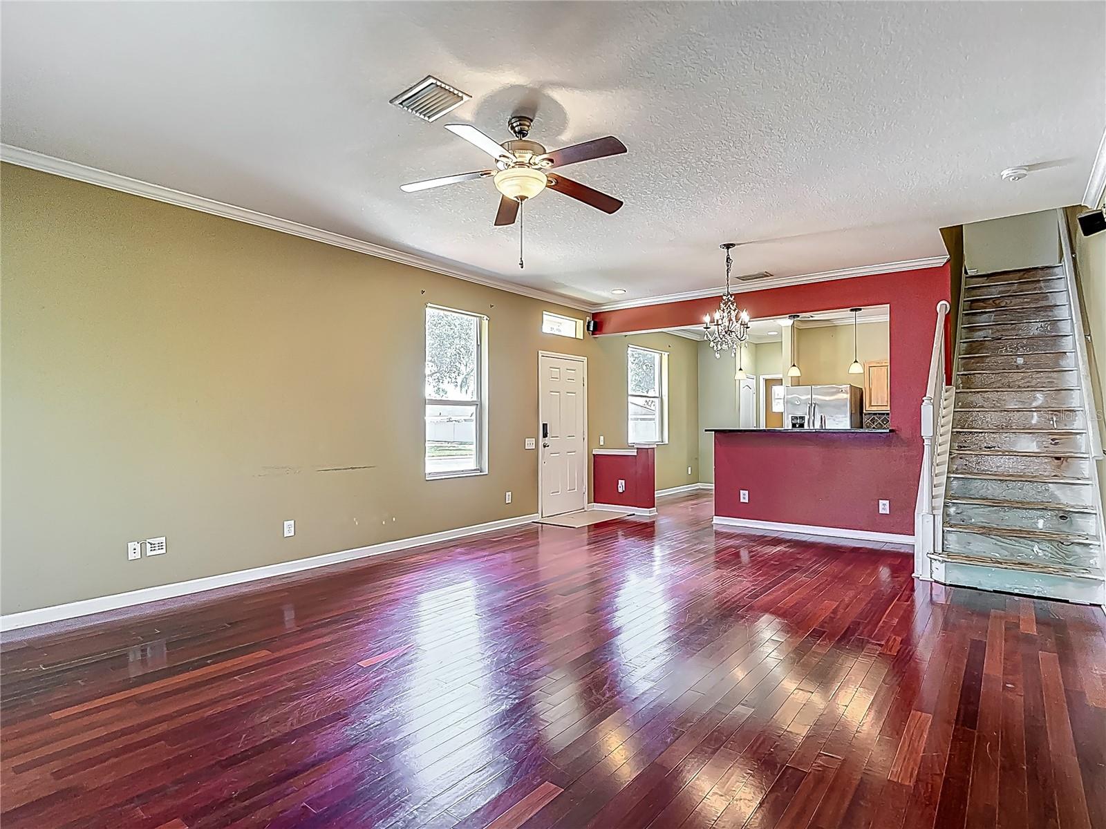 View from great room towards kitchen and stairs. Carpet was removed from stairs and 2nd floor. Behind you is the large sliding glass doors leading to the lanai.