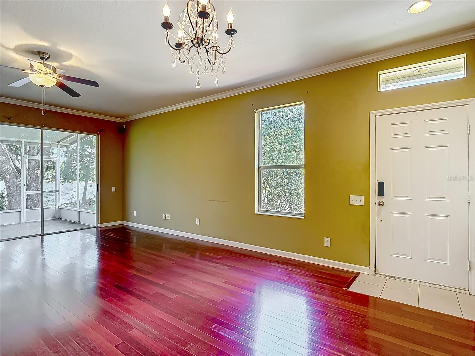 You are at the breakfast bar, view into great room. Kitchen is behind you, front door is to your right.