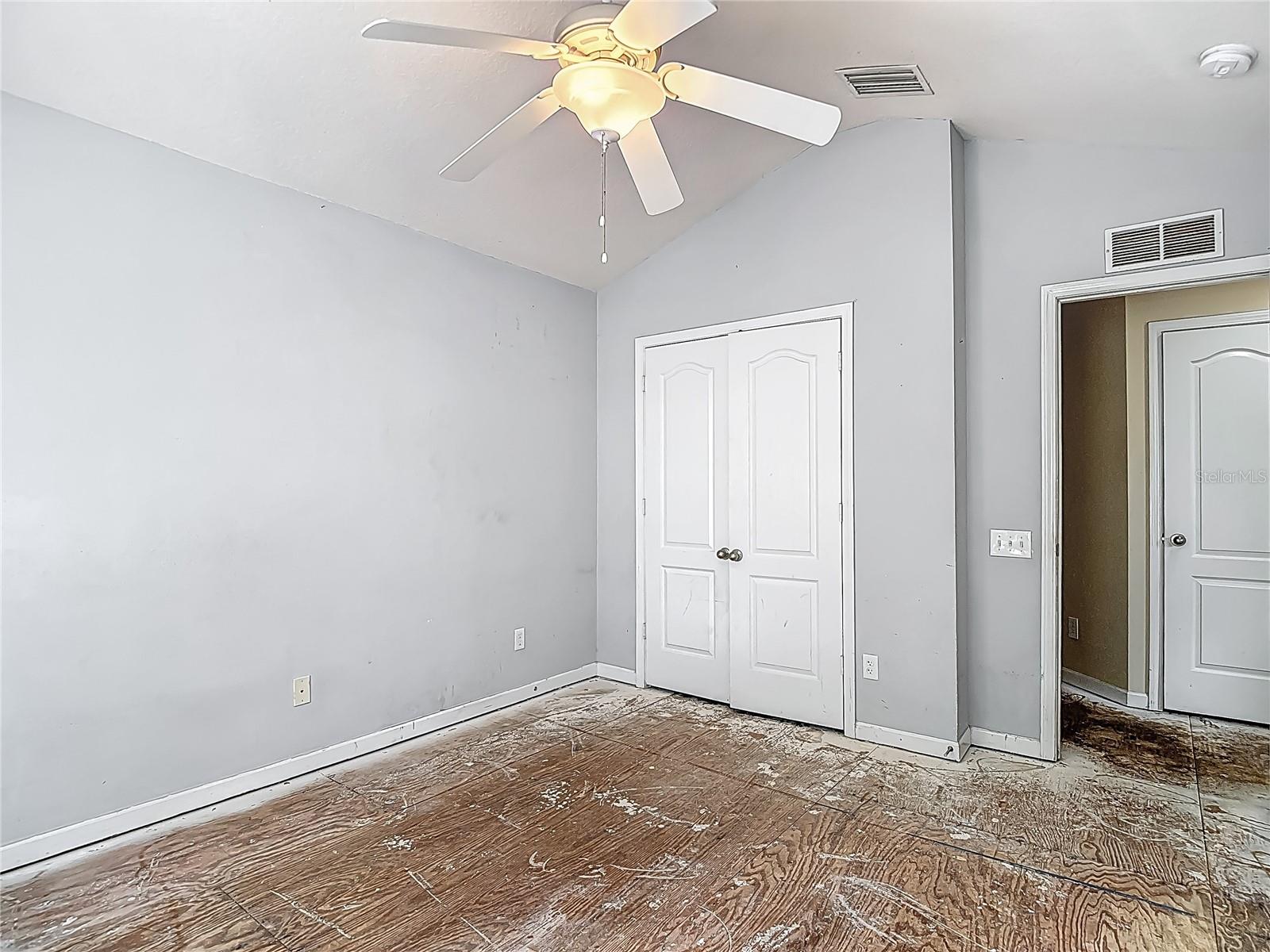 Bedroom 1. French doors for the closet. Bath entrance on your immediate right (of of view in pic) The closed door towards the right is a storage closet.