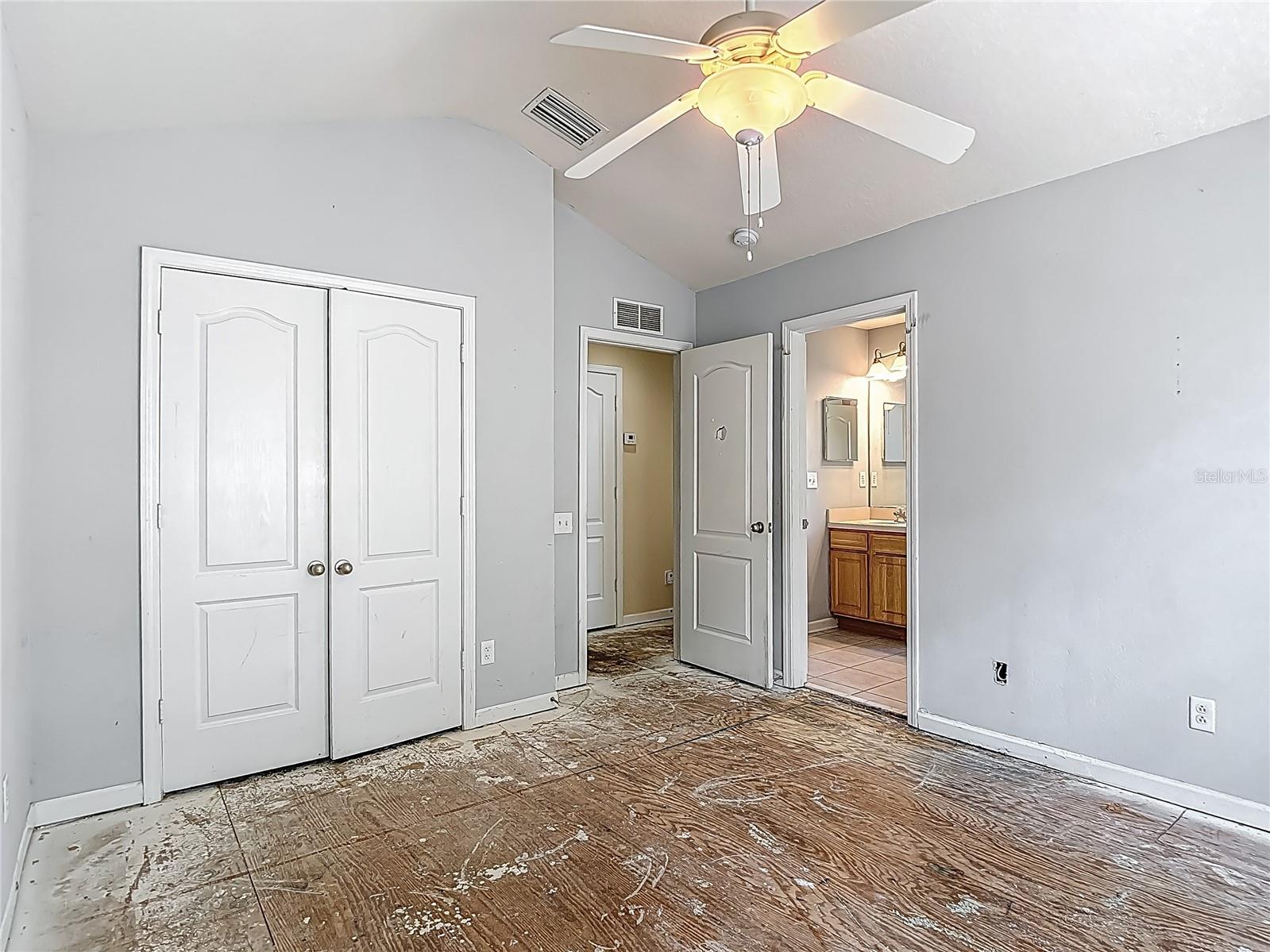 Bedroom 1. French doors for the closet. Bath entrance straight ahead. There is another entrance door to this bath, just left of the vanity.