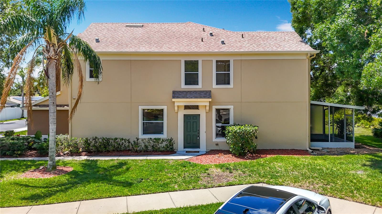 Front door entrance. End units have 5 windows more than center units, helping bring in more natural light. Left window: eating space in kitchen; right window in great room. Right upper window: Primary bath, middle upper window is middle bedroom, far left upper window is 2nd floor full bath.