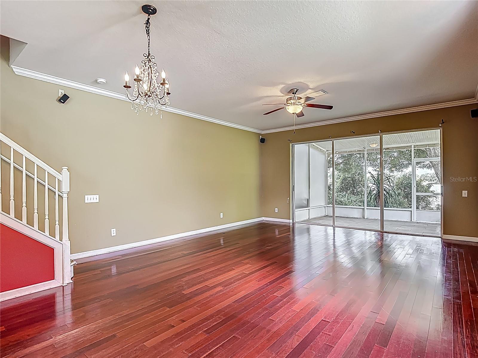 Entrance door is behind you. View into great room and the screen enclosed lanai, along with the stairs lading to the bedrooms and baths on 2nd floor.  To the left is the kitchen, powder room & garage entrance.