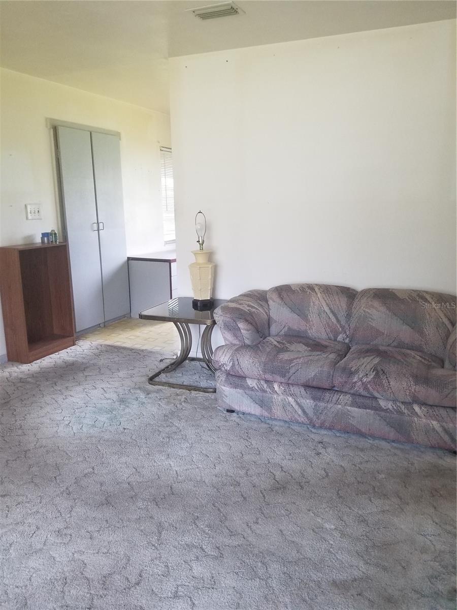 Living room looking towards kitchen entrance.