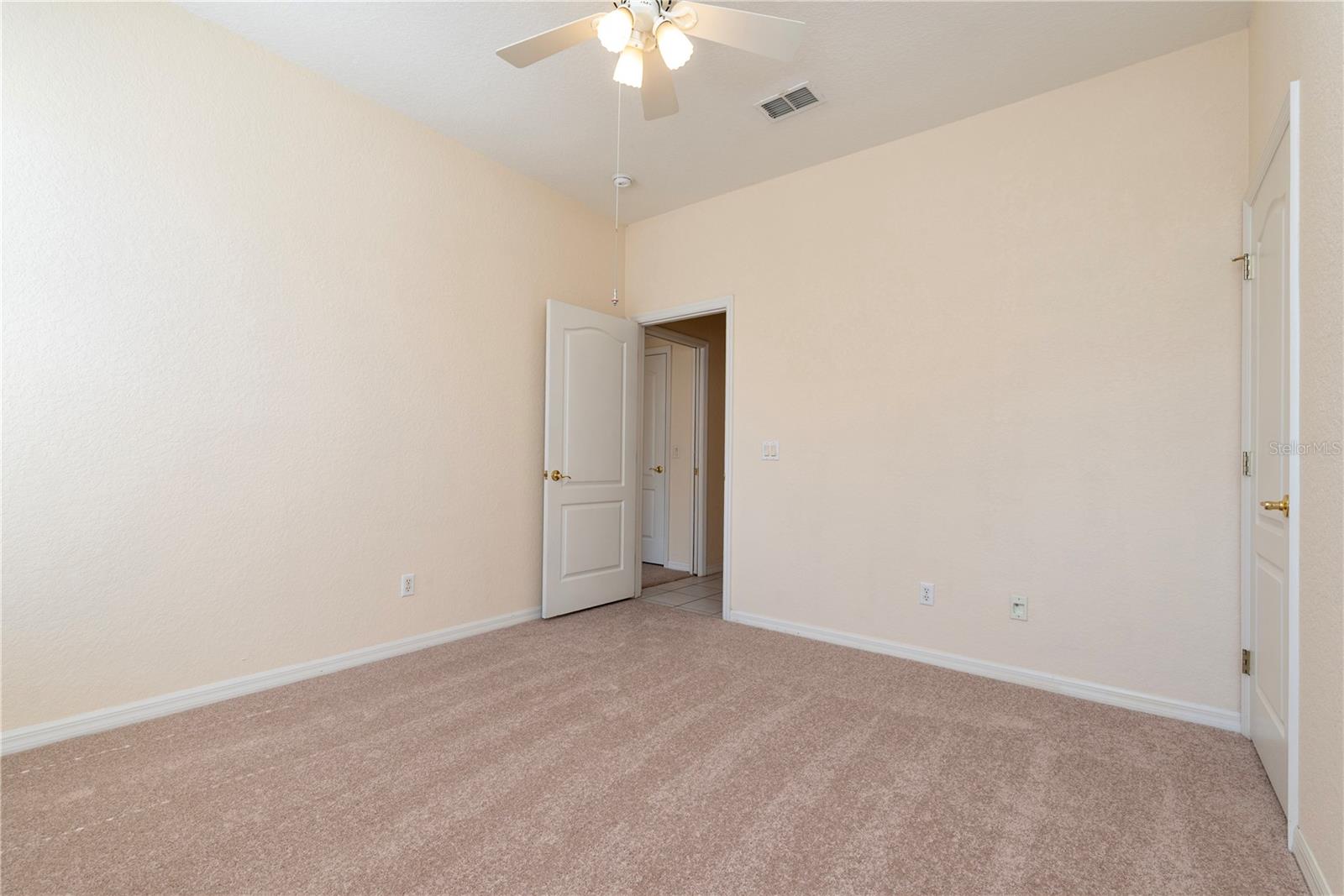Bedroom 2 with new carpet and walk in