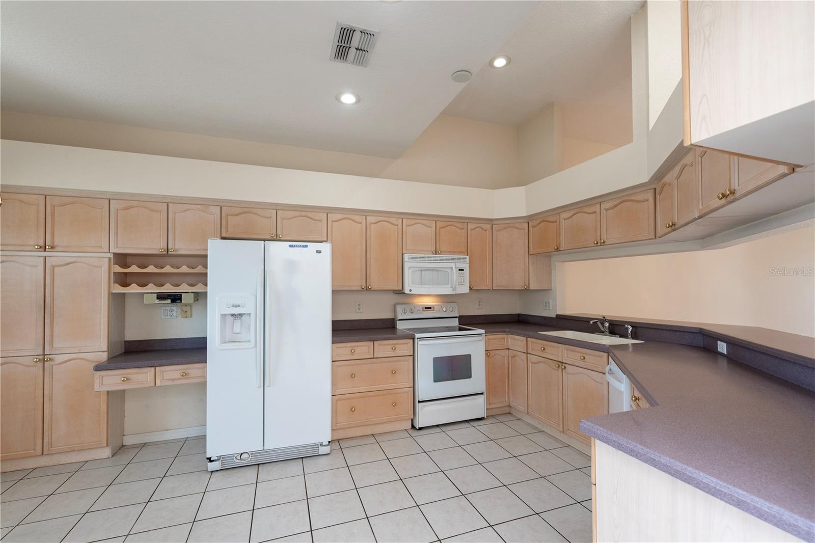 Kitchen with built in desk and wine rack.