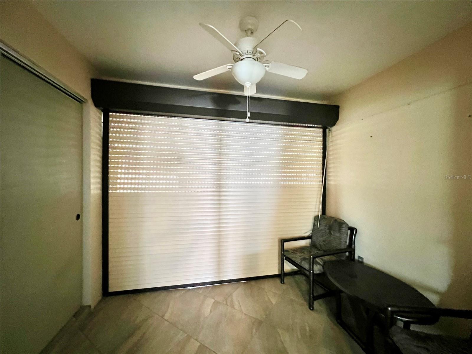 Primary bathroom sink vanity area with Hurricane roll down shutters