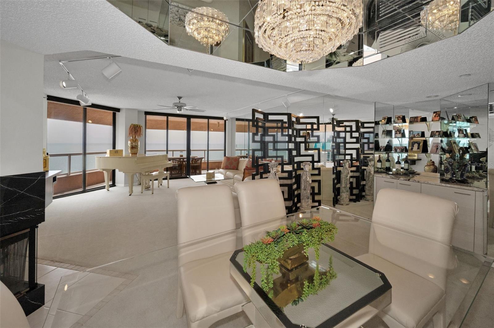 Residence features an Interior Ambiance and Design Elements including Crystal Chandelier Lighting, Wood Burning Fireplace, Spacious Open Floor Plan with an Abundance of Natural Light and Views from Every Room!
