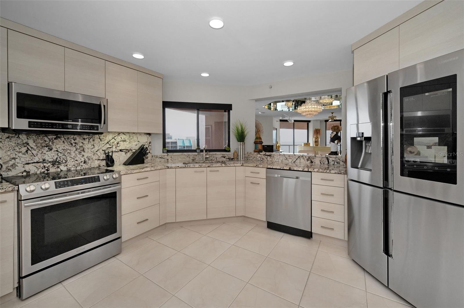 Light & Bright Cucina Features the Samsung Stainless Collection, the Finest Imported Italian Marble Surfaces, and Custom Euro-Style Italian Cabinetry!