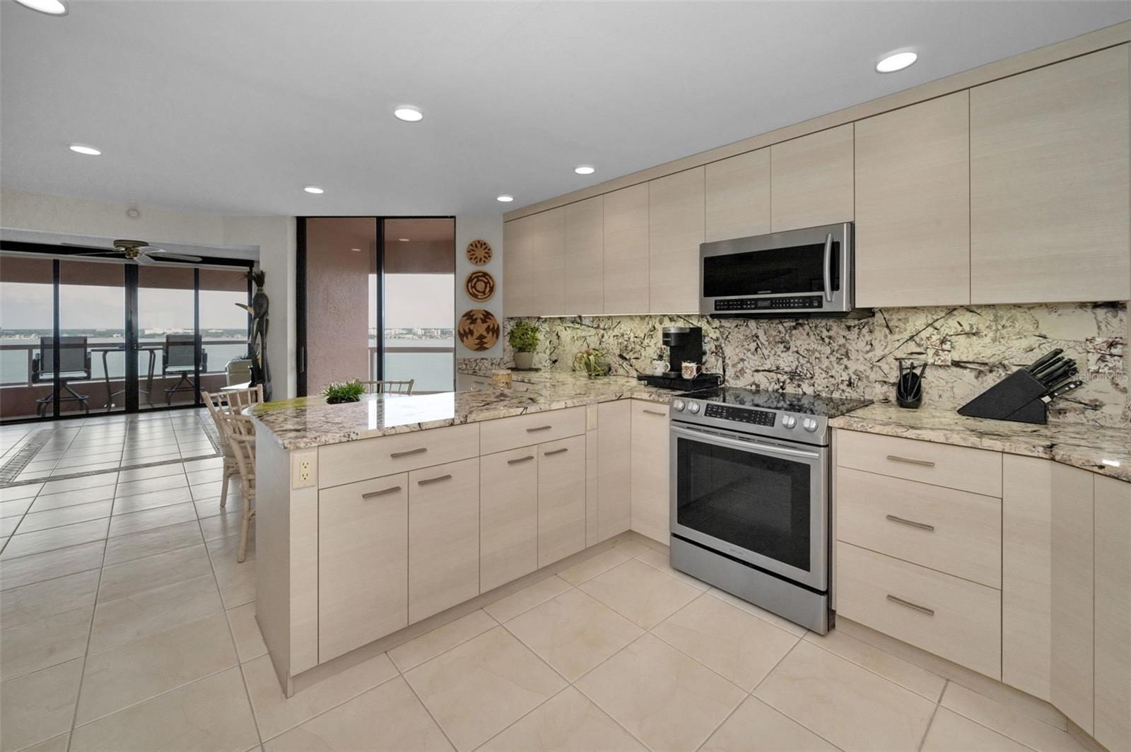 Light & Bright Cucina Features the Samsung Stainless Collection, the Finest Imported Italian Marble Surfaces, and Custom Euro-Style Italian Cabinetry!