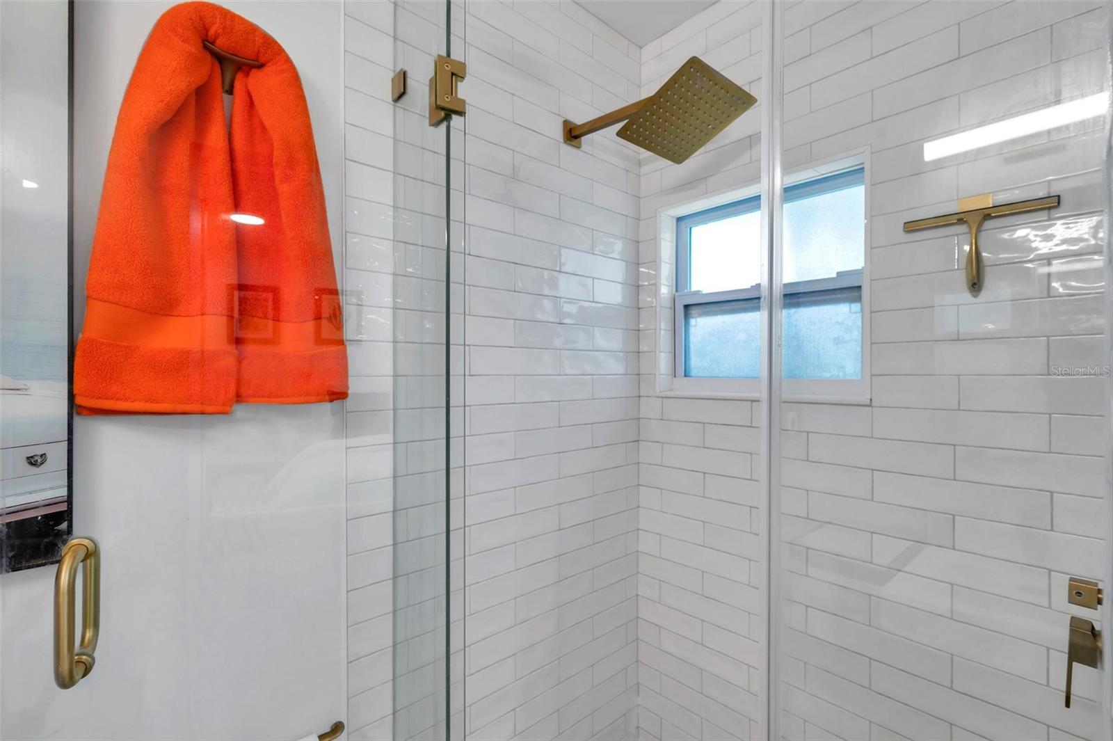 Updated bathroom with new floor to ceiling shower tiles, new fixtures, new vanity and new toilet