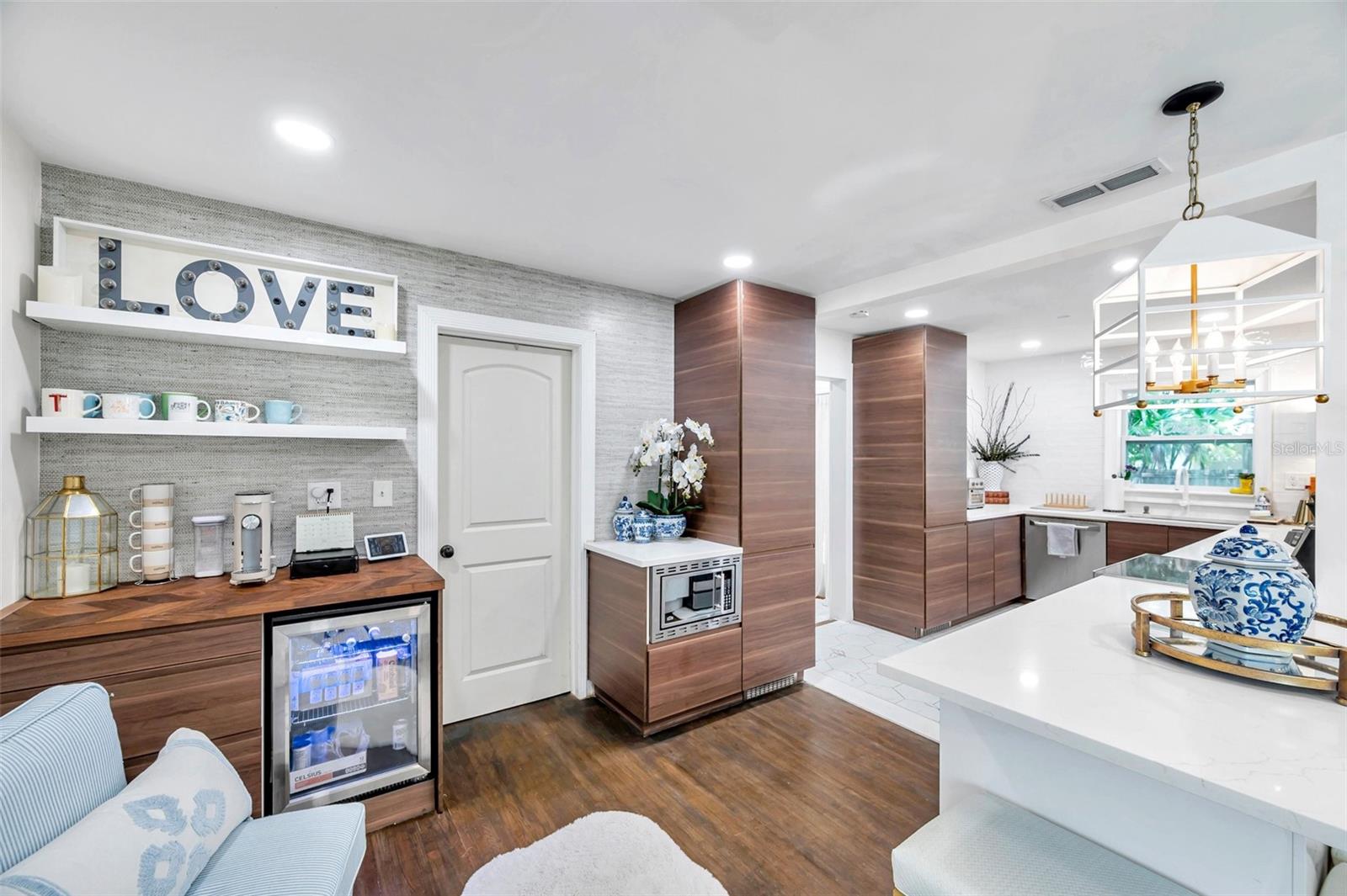 Beverage station designed with the perfect wall paper accent and open shelving