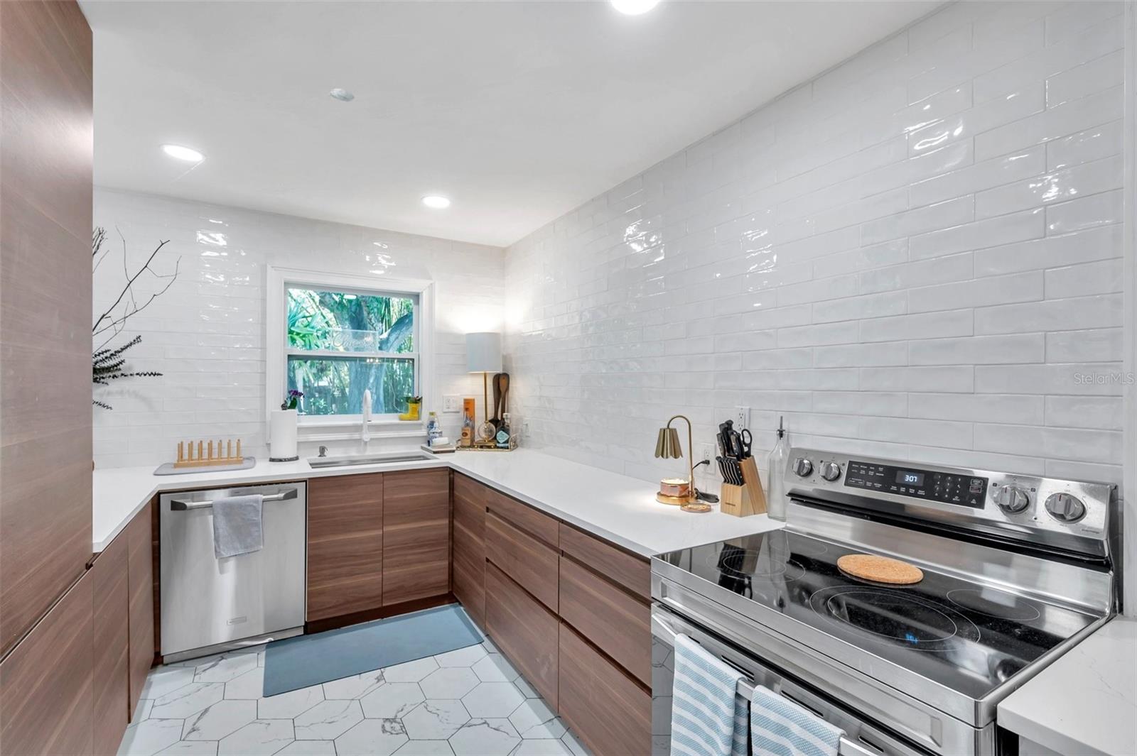 Cabinetry with no shortage of storage with features like lazy Susan, deep drawers, dual fridge and freezer