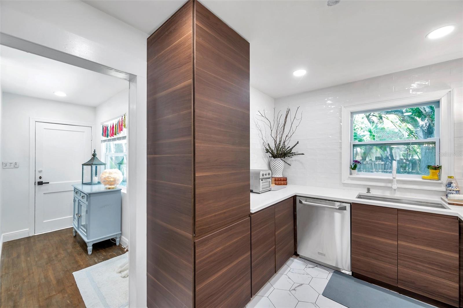 Kitchen designed with sophisticated features including surround backsplash encompassing the entire kitchen wall space