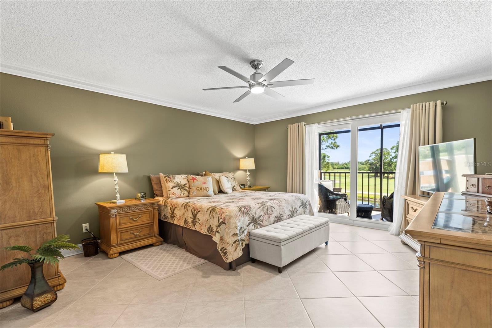 LARGE MASTER BEDROOM WITH IMPACT STORM SLIDING DOOR TO PATIO