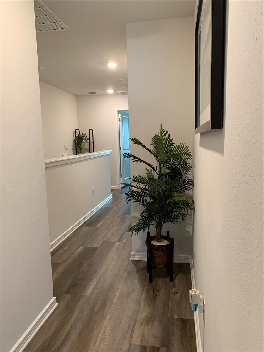Walkway between primary and 2nd bedroom