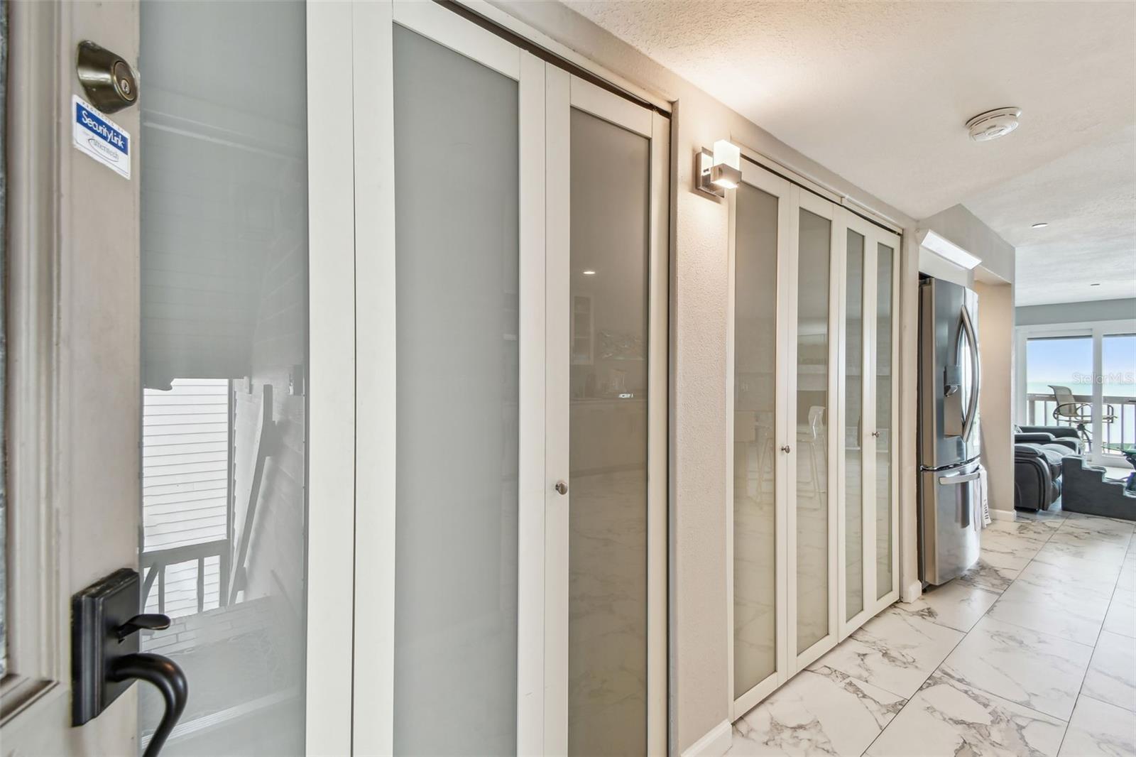 Hallway from front door with pantry closet and laundry closet