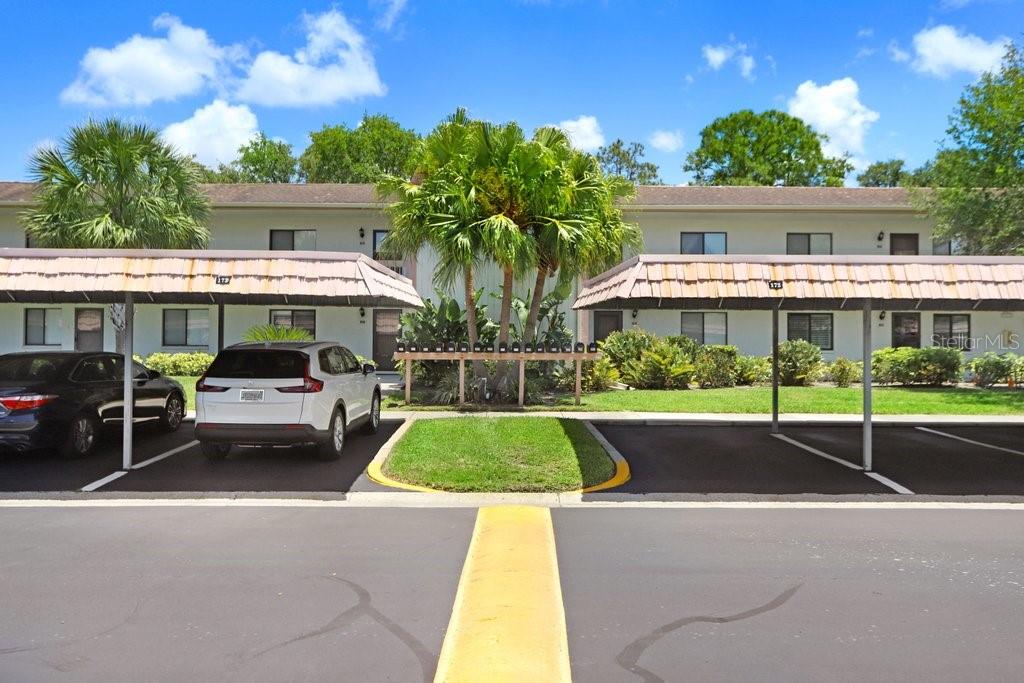 condo building, mailboxes, and assigned covered carport parking