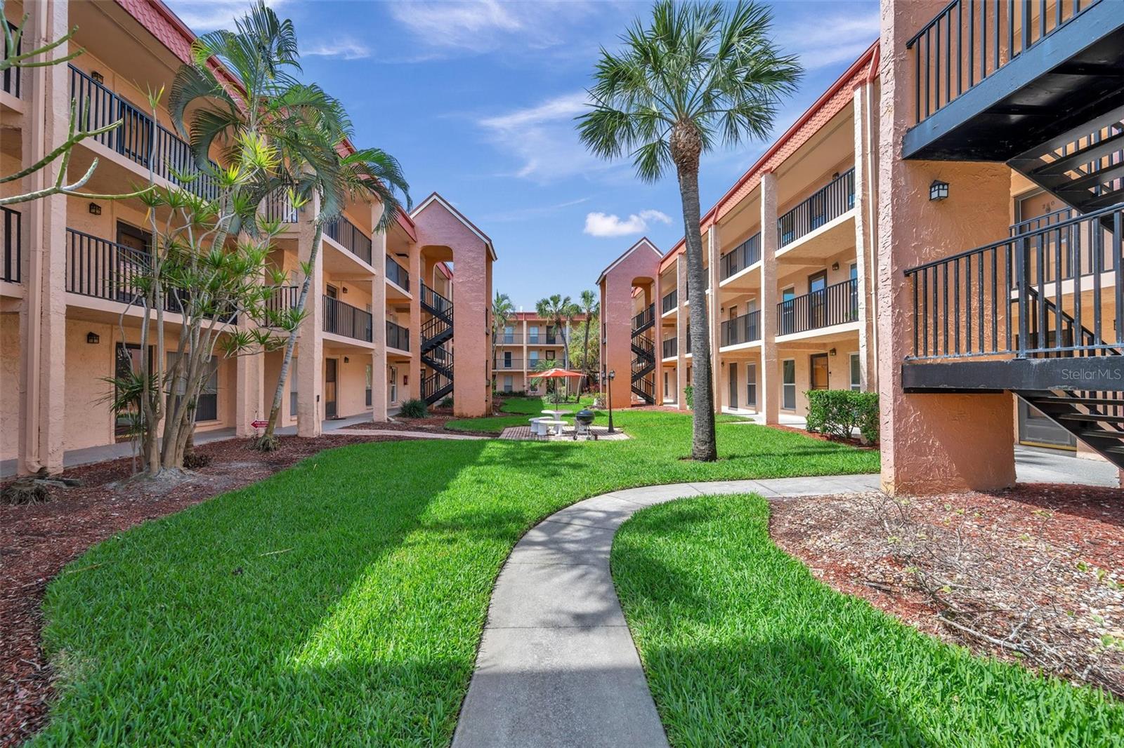 Courtyard of Unit 360 with picnic table and grill